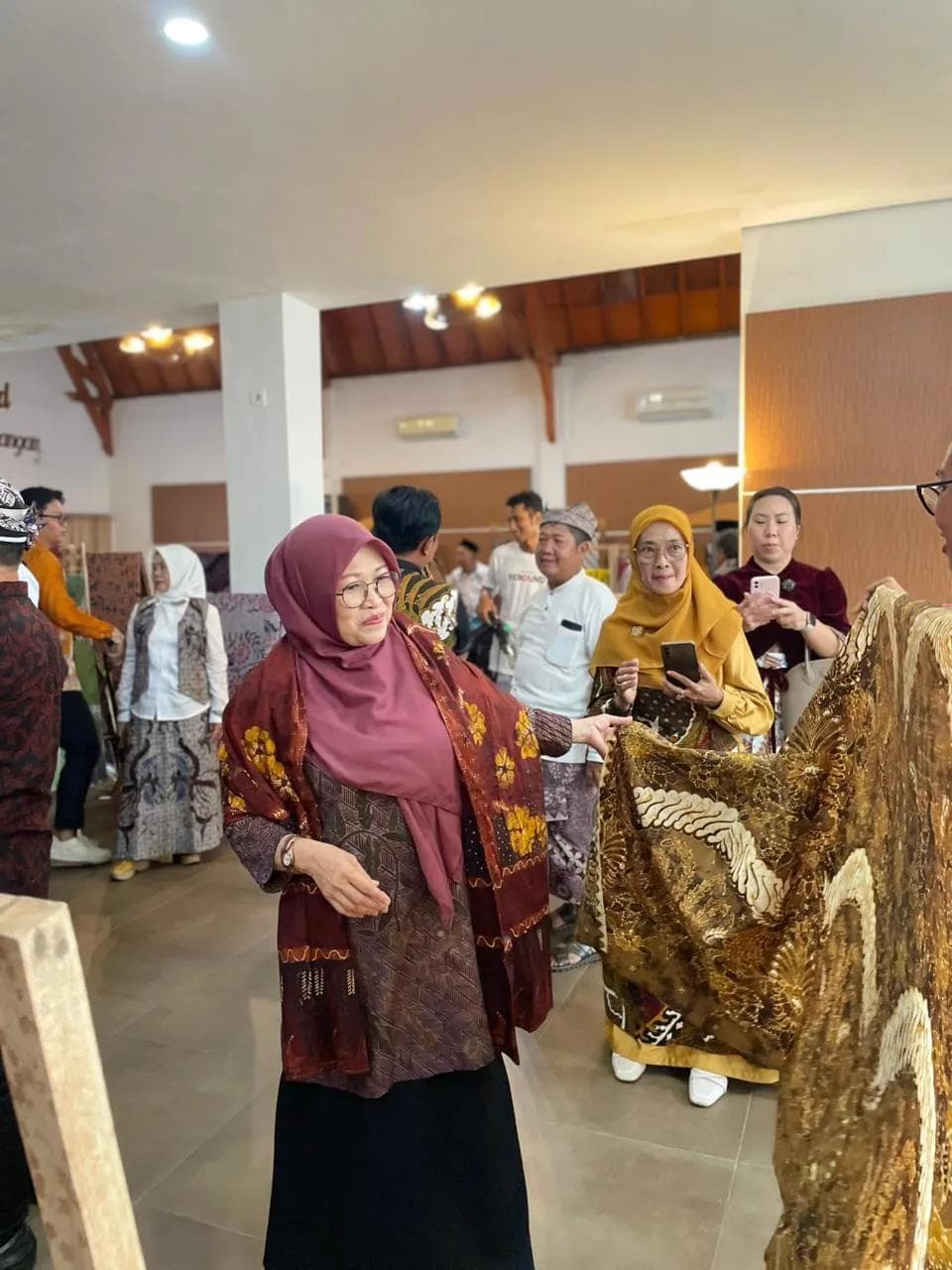 Visitor viewing traditional batik fabrics
