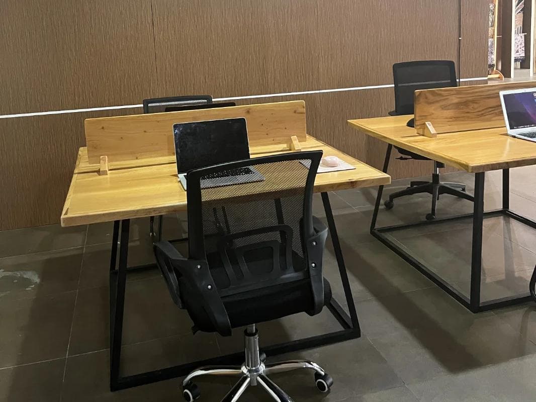Shared workspace with wooden desks and ergonomic office chairs