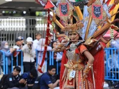 BEC 2026 performers wearing elaborate Perang Bayu-inspired costumes during the Banyuwangi Ethno Carnival parade.